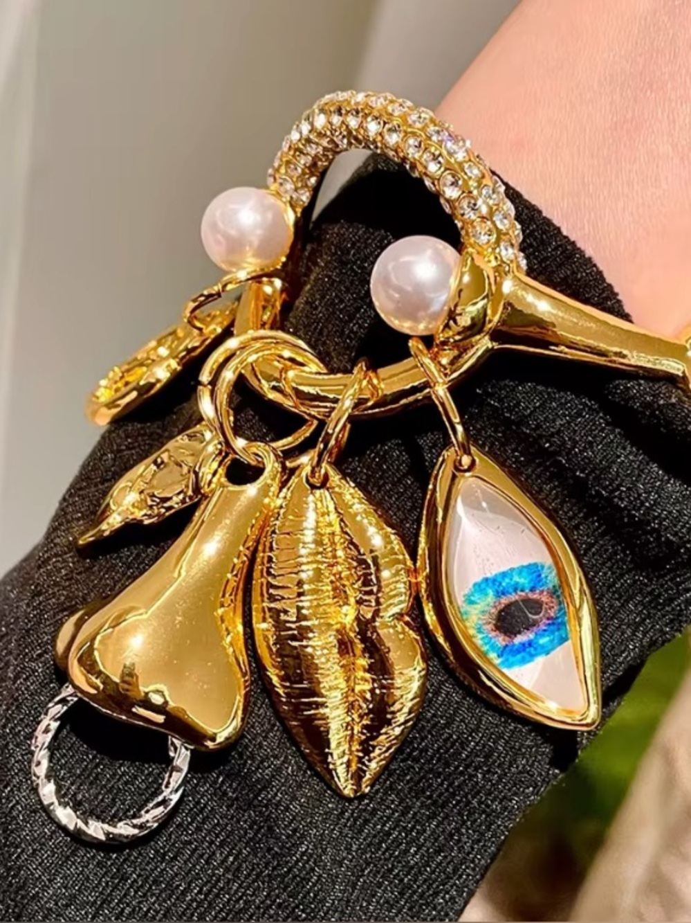 Schiaparelli Inspired Gold Charm Bracelet with Pearls and Blue Eye Accent